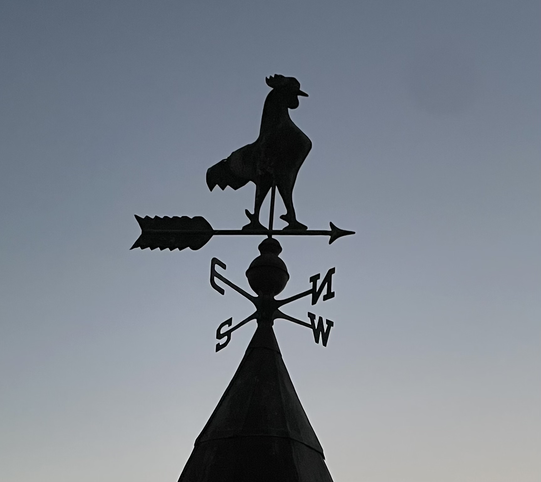 Chicken weather vane above the house