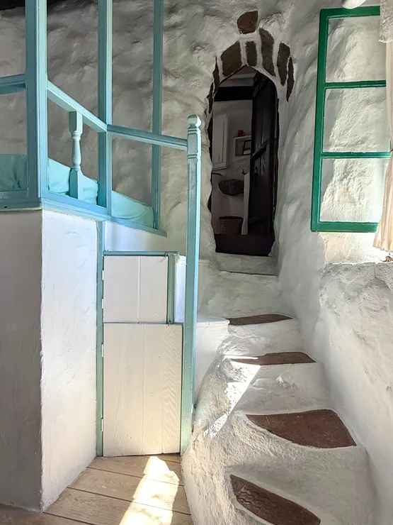 Green bedroom door opening onto stone steps at Eco House Patmos