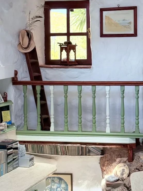 Small window and pale green cabinets in the kitchen at Eco House Patmos