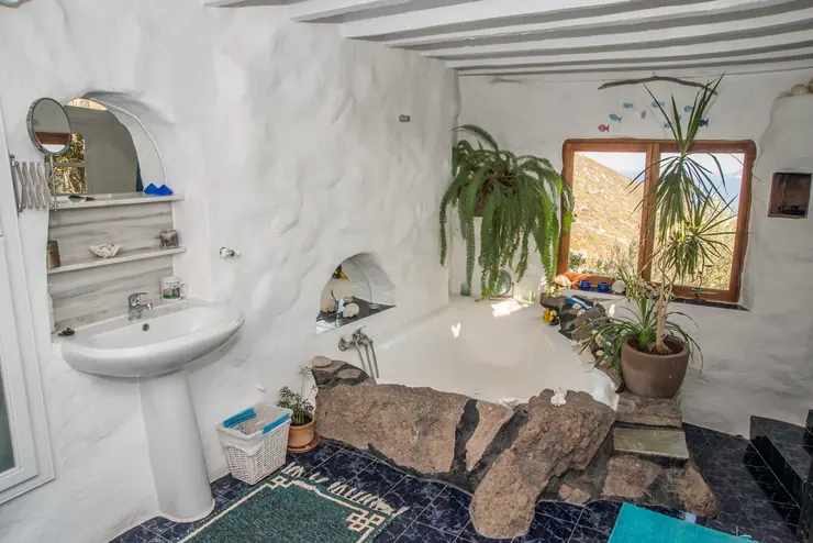 Eco House Patmos – main bathroom with a rock-edged bathtub