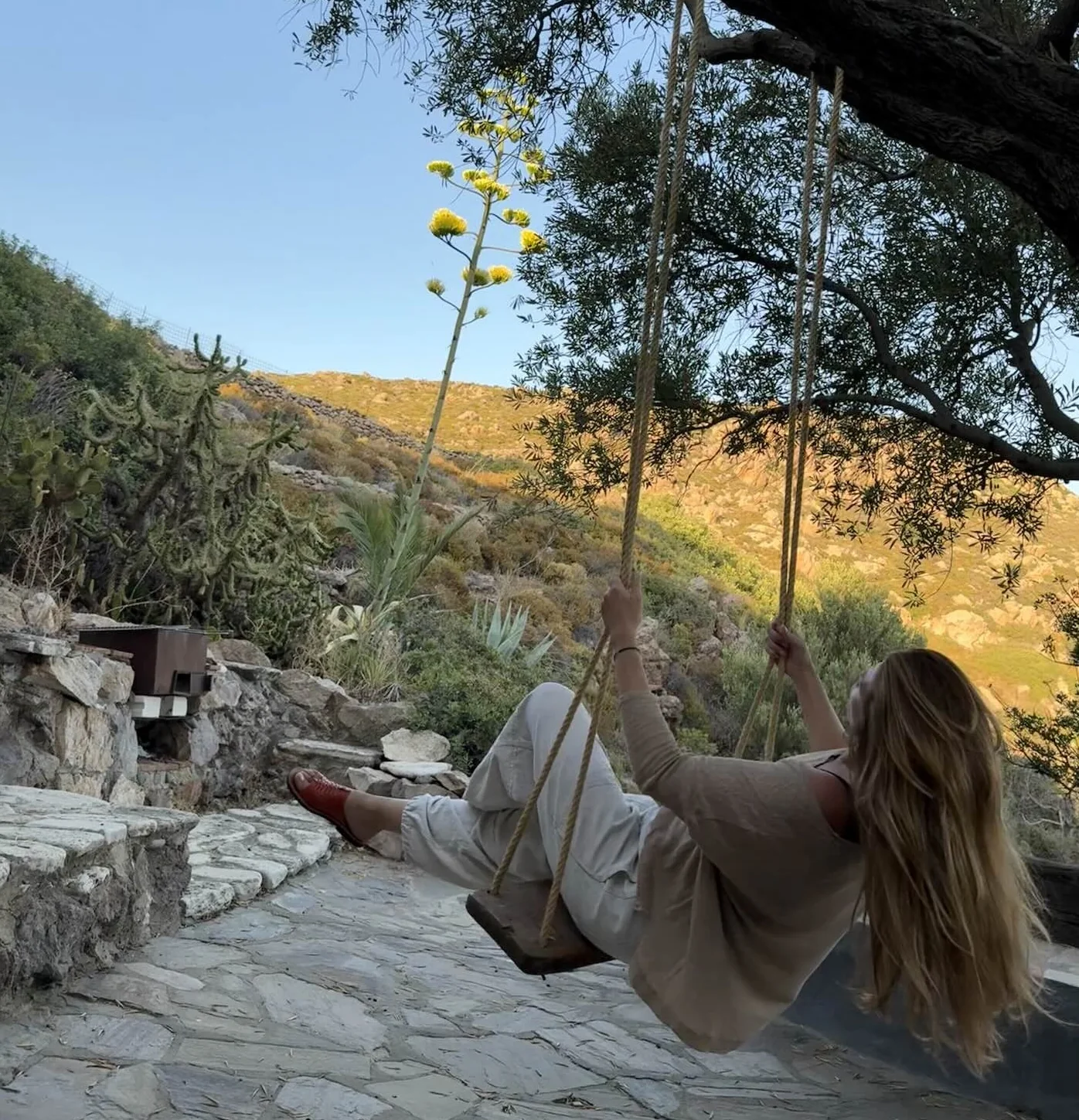 A guest on the tree swing overlooking the Patmos hills